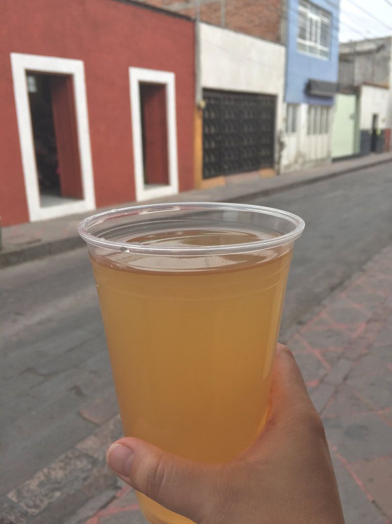 This is Tepache, it is a prehispanic beverage. it was made of fermented corn, but now days it is made with the fermentation of pineapple. Delicious! a real food experience
